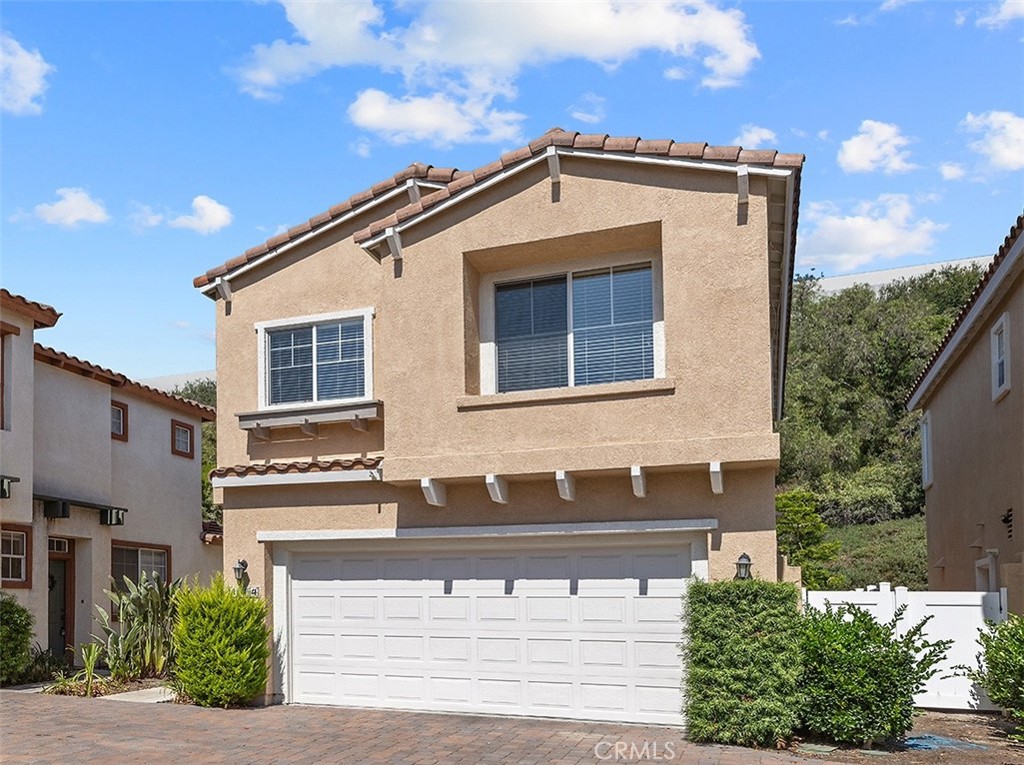 Detached condo located at the back of the desirable Flores Los Alisos community, surrounded by lush greenery. - 144 Las Flores, Aliso Viejo CA 92656 - photo 1