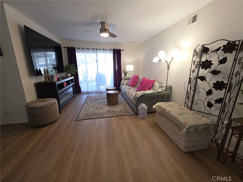 Living Room with Laminate Floors, TV Wall, Sliding Door leading to Backyard - 21 CAMBRIA Lane, Aliso Viejo CA 92656 - photo 12