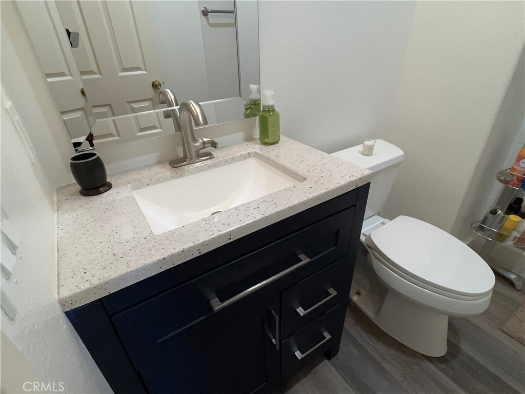 Designer detail with speckled quartz top, polished chrome faucet, and sleek navy cabinetry — stylish and​​‌​​​​‌​​‌‌​​‌‌ - 29 Waxwing, Aliso Viejo CA 92656 - photo 14