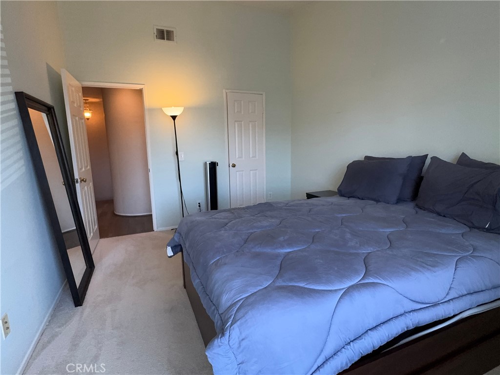 Spacious carpeted bedroom with abundant light, large floor mirror, and easy flow to hallway baths. - 29 Waxwing, Aliso Viejo CA 92656 - photo 16