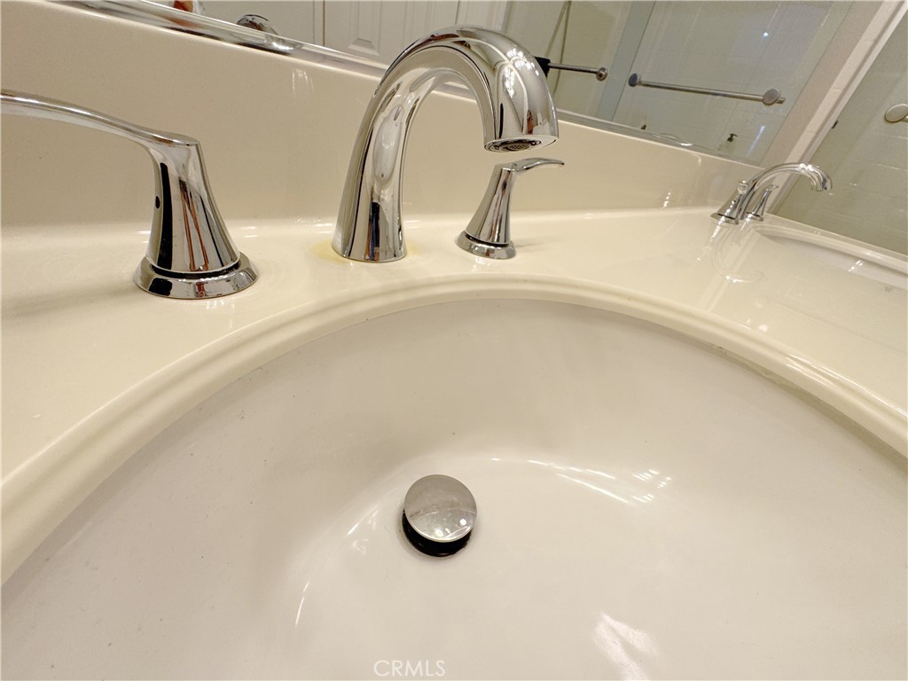 Clean modern finish detail with polished chrome fixtures and glossy white vanity top — move-in ready quality. - 29 Waxwing, Aliso Viejo CA 92656 - photo 21