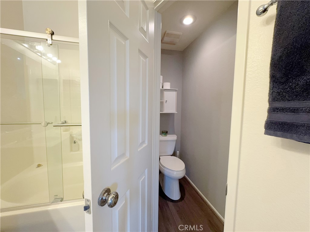 Smartly zoned bath layout with private water closet, glass shower, and updated wood-look flooring. - 29 Waxwing, Aliso Viejo CA 92656 - photo 22