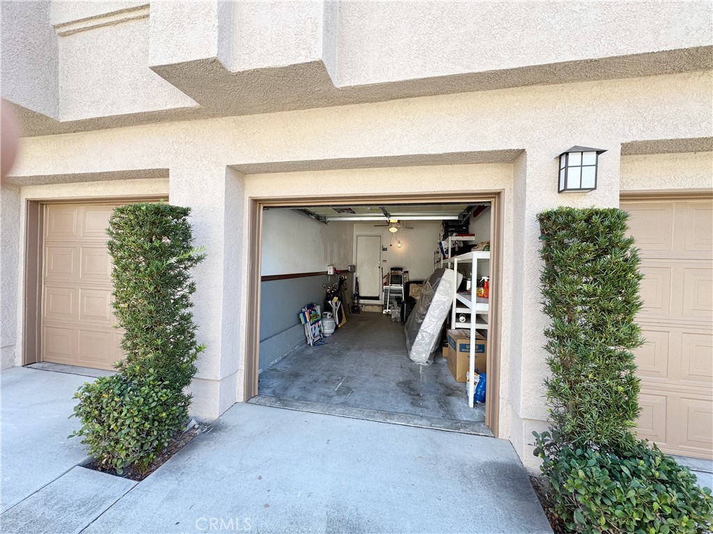 Private garage with extra overhead storage in a well-maintained stucco building with manicured landscaping. - 29 Waxwing, Aliso Viejo CA 92656 - photo 26