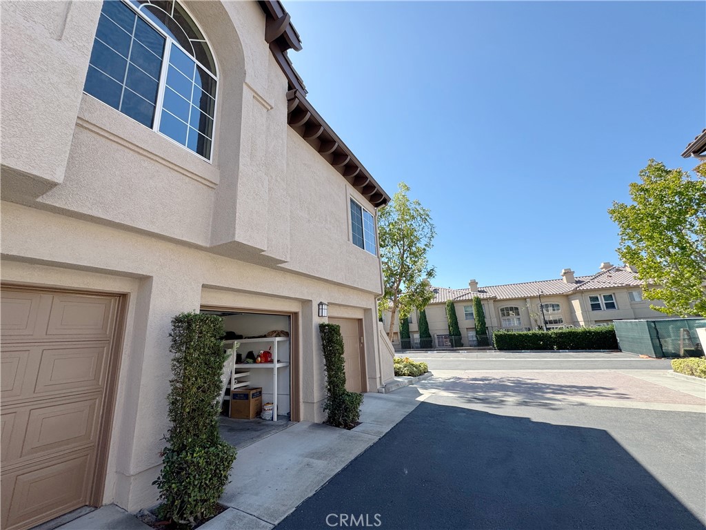 Sunny exterior with private garages and open drive court in gated Seacove Place. - 29 Waxwing, Aliso Viejo CA 92656 - photo 27