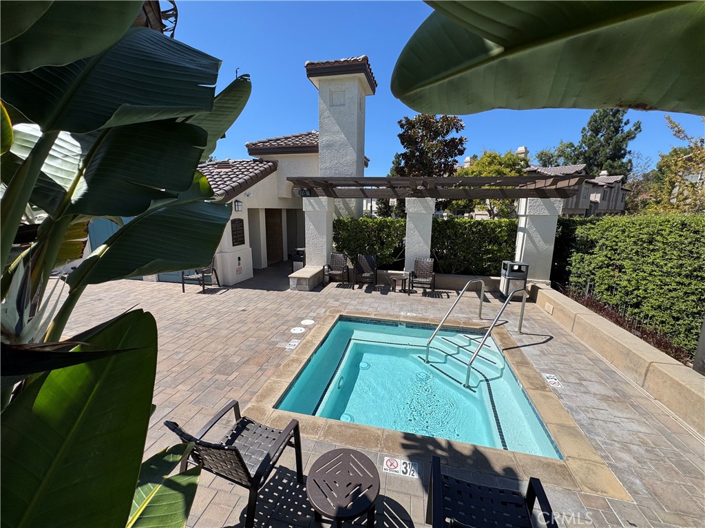 Private community spa with pergola seating and tropical landscaping — perfect for relaxing year-round. - 29 Waxwing, Aliso Viejo CA 92656 - photo 29