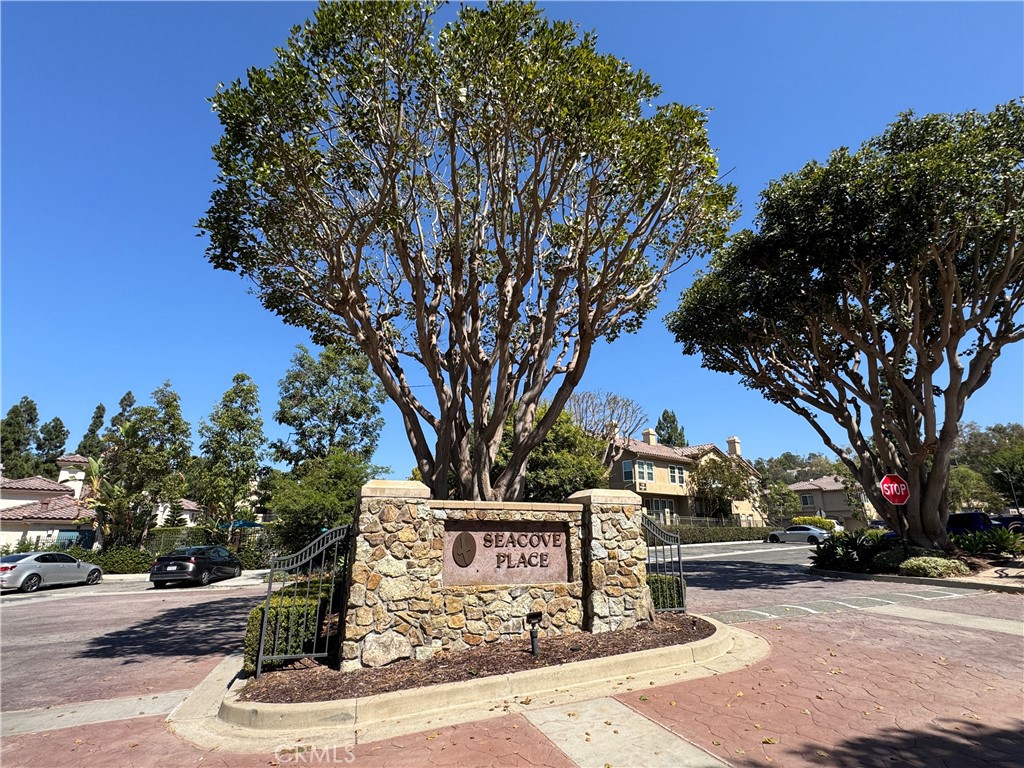 Gated Seacove Place entry with stone monument, mature trees, and well-kept grounds. - 29 Waxwing, Aliso Viejo CA 92656 - photo 34