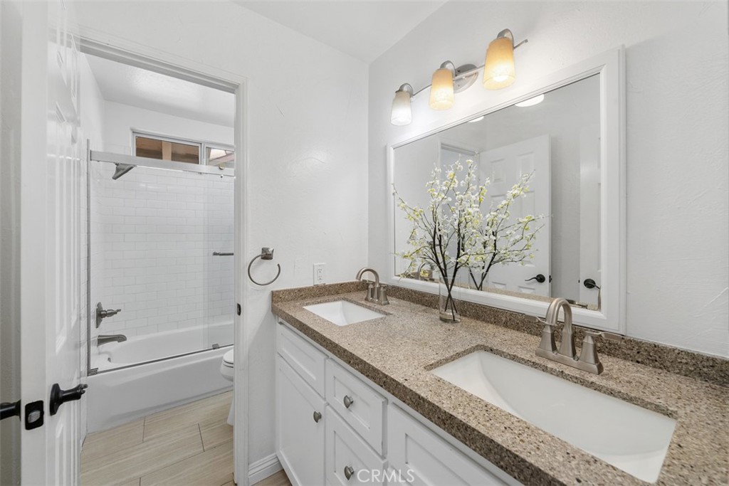 upstairs secondary bathroom with dual sinks and tub/shower - 36 Tanglewood, Aliso Viejo CA 92656 - photo 24