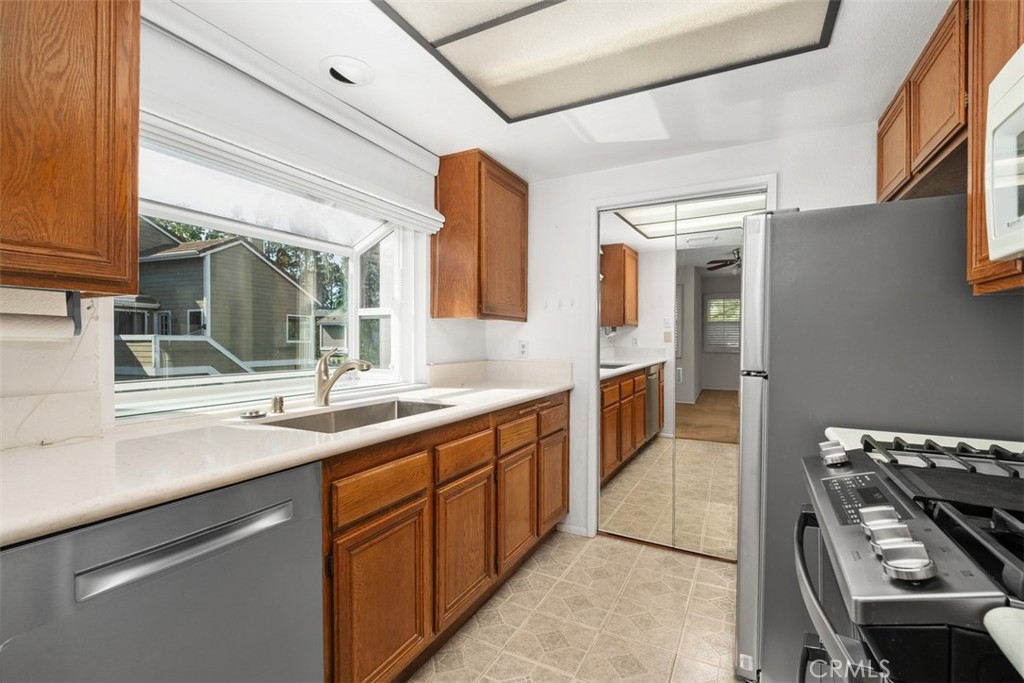 Newer Stainless-Steel Appliances; Mirrored Door Conceals Laundry Room with Washer/Dryer Included. - 40 Hollyhock, Aliso Viejo CA 92656 - photo 10