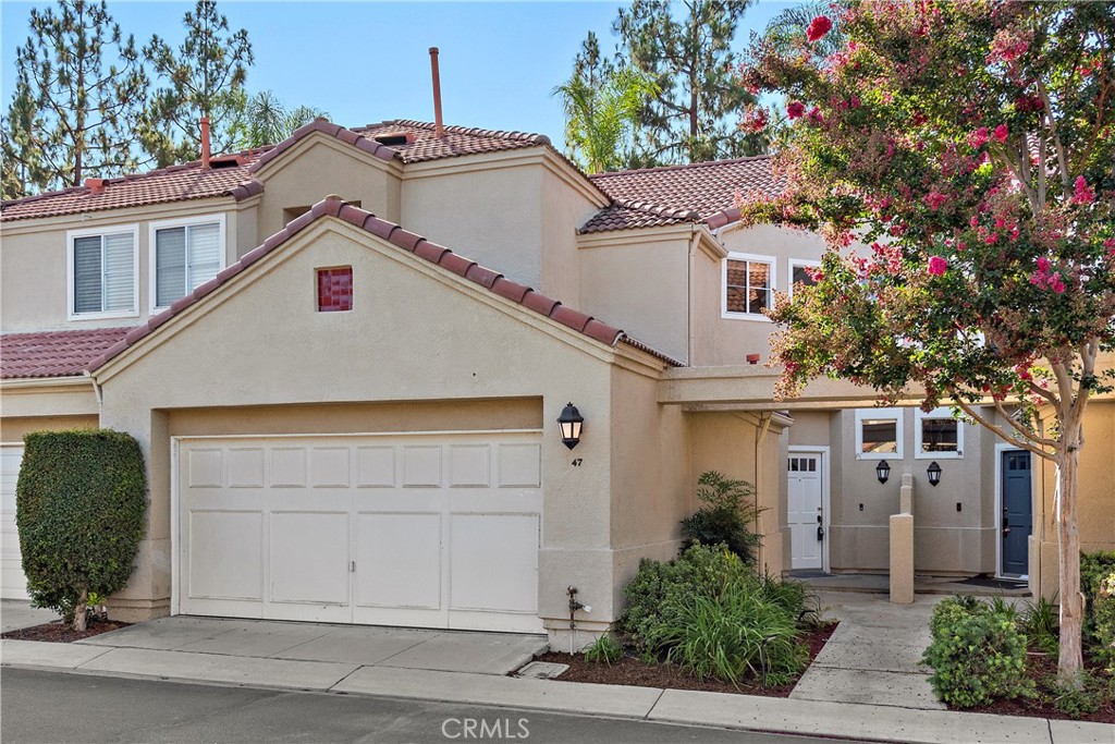 Mature landscaping and ample parking in the community. Garage door has been updated since photo. - 47 Donatello, Aliso Viejo CA 92656 - photo 25