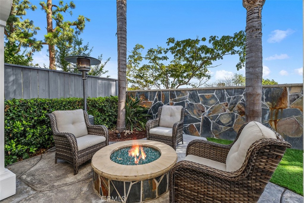 Backyard Patio (w/ Outdoor Fire pit - Fire digitally added). Original unaltered photo shown adjacent. Buyer to verify op - 6 Briarglenn, Aliso Viejo CA 92656 - photo 19