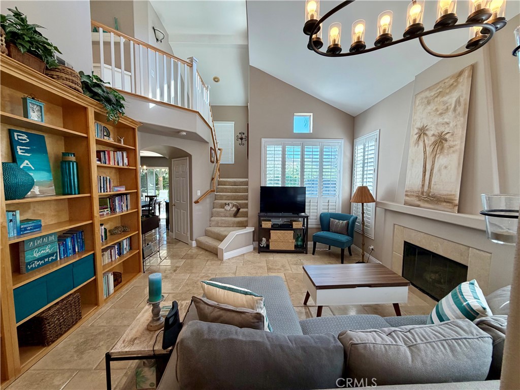 Soaring cathedral ceilings and two stories of windows flood the living room with natural light - 6 Mallorn, Aliso Viejo CA 92656 - photo 2