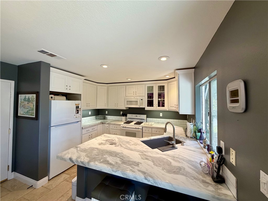 Crisp white cabinetry with glass front display - 6 Mallorn, Aliso Viejo CA 92656 - photo 7
