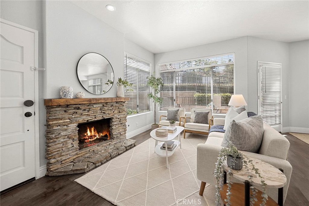 he heart of the home. Gather around the stunning stacked stone fireplace while oversized windows fill the room with natu - 66 Cinnamon Teal, Aliso Viejo CA 92656 - photo 5