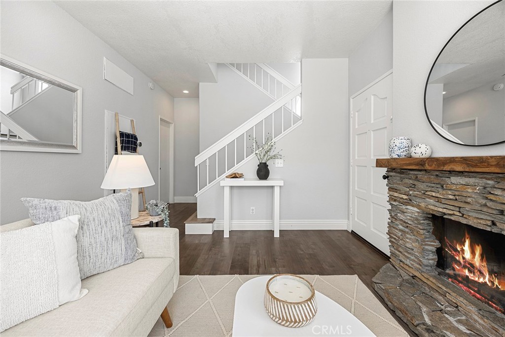 An entry that makes every homecoming feel special. Fireplace flame has been digitally added and virtually staged for eff - 66 Cinnamon Teal, Aliso Viejo CA 92656 - photo 8