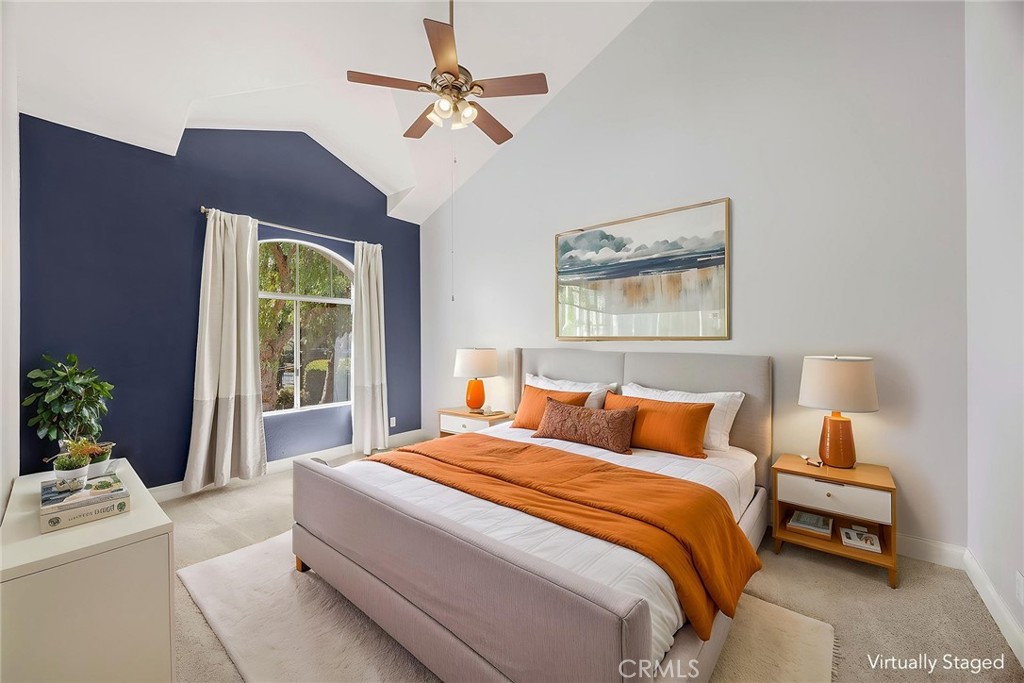 Spacious primary bedroom featuring soaring vaulted ceilings, a large arched window and plenty of room for a king-size be - 66 Cinnamon Teal, Aliso Viejo CA 92656 - photo 19