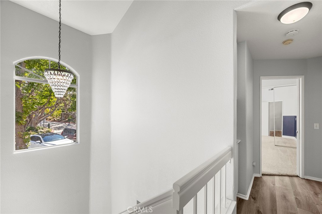 Natural light pours through the elegant arched window, while the chandelier adds a touch of sophistication to the upstai - 66 Cinnamon Teal, Aliso Viejo CA 92656 - photo 30