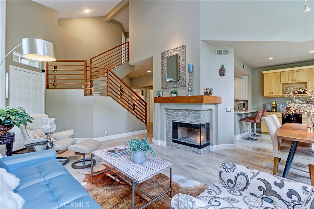The staircase has been remodeled by removing high, curved drywall and opening it up with a custom solid walnut banister. - 89 Montara Drive, Aliso Viejo CA 92656 - photo 1