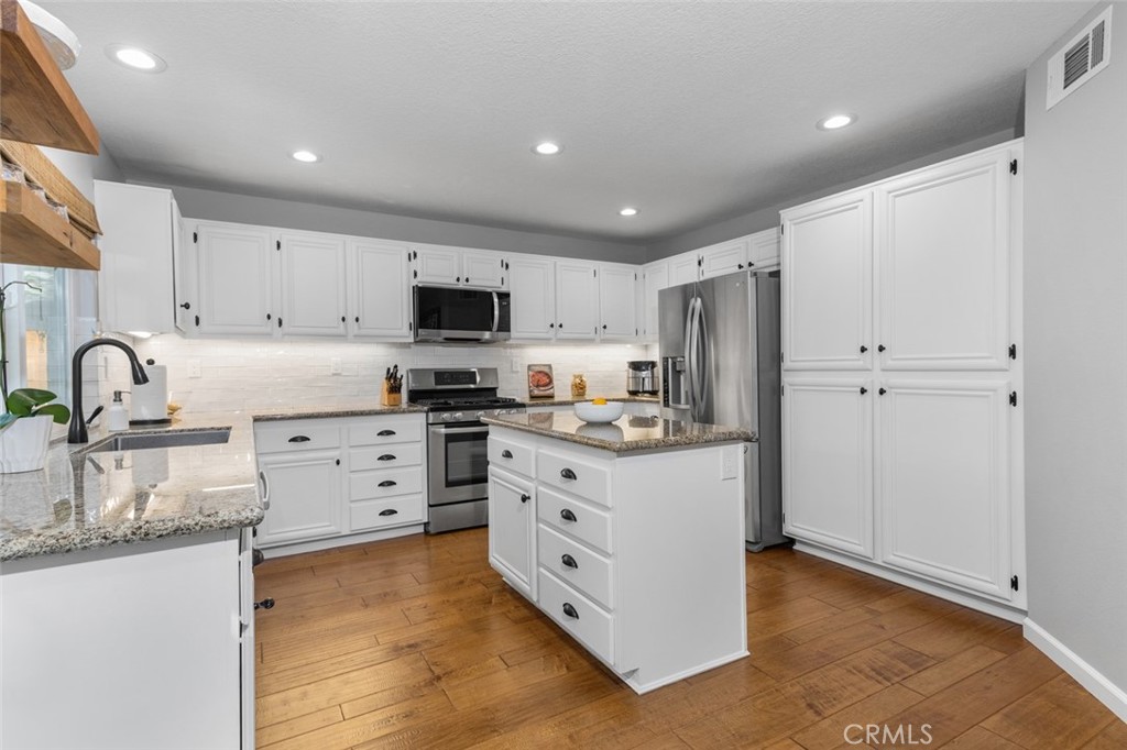 Kitchen features an island and cabinet pantry for plenty of storage - 9 Sequoia, Aliso Viejo CA 92656 - photo 11