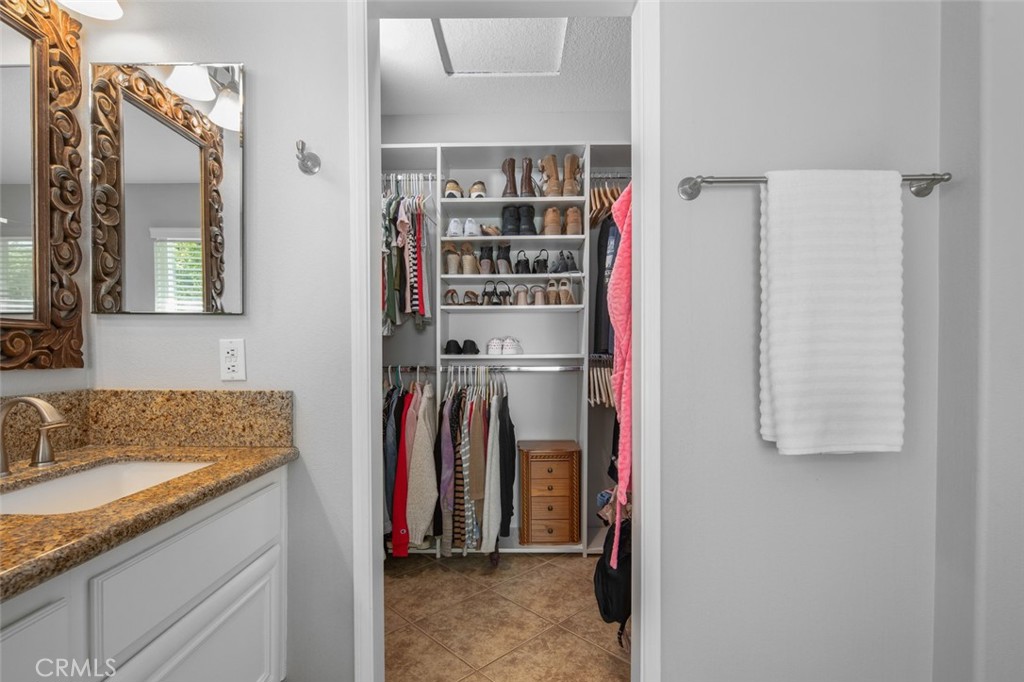 Closet organizers in the Walk-in Primary Closet make organized living simple - 9 Sequoia, Aliso Viejo CA 92656 - photo 21