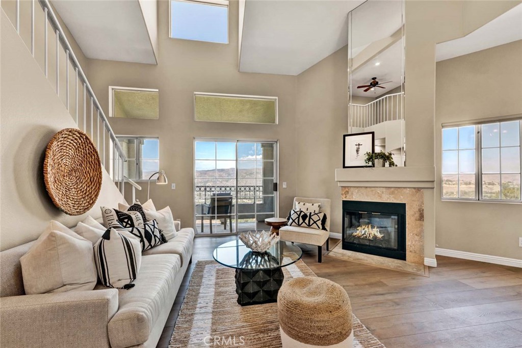 Cathedral ceilings, luxury vinyl flooring, panoramic views from every window, and a cozy fireplace. - 7833 E Viewrim, Anaheim Hills CA 92808 - photo 1