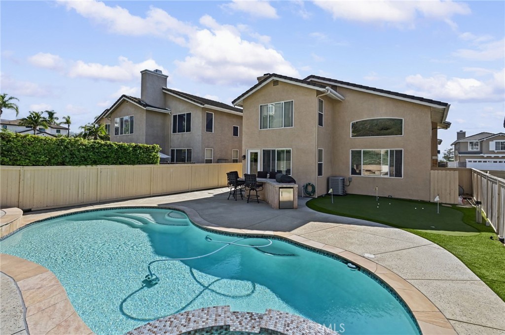 View of the pool and the back side of the house. Don't miss the private putting green - 1028 S Brianna Way, Anaheim CA 92808 - photo 4