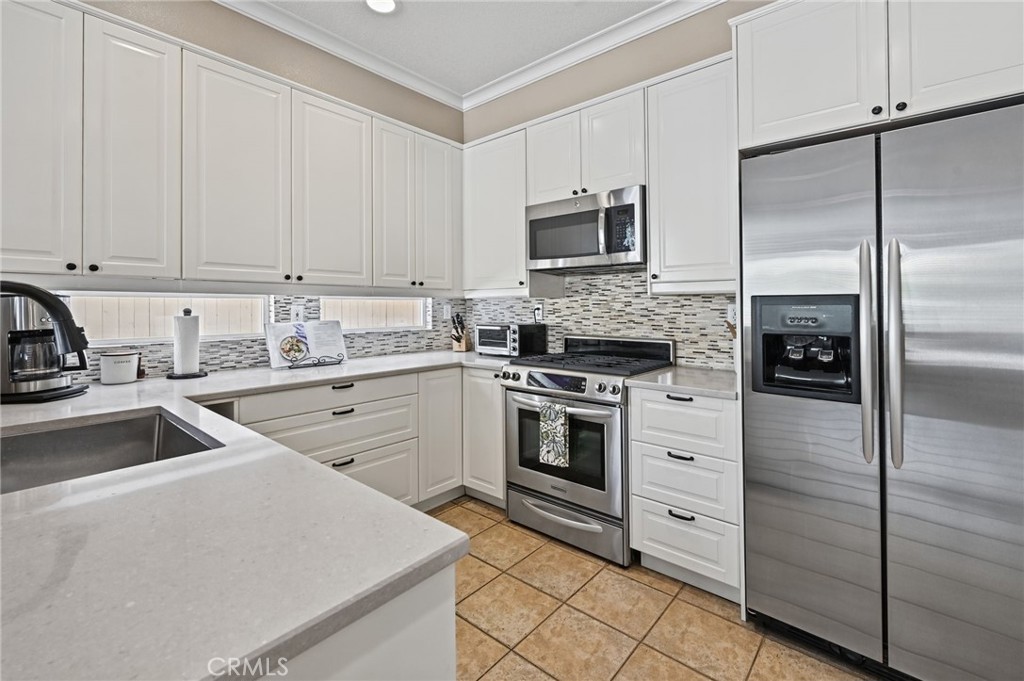 Remodeled kitchen has soft close drawers and cabinets and SS appliances - 1028 S Brianna Way, Anaheim CA 92808 - photo 14