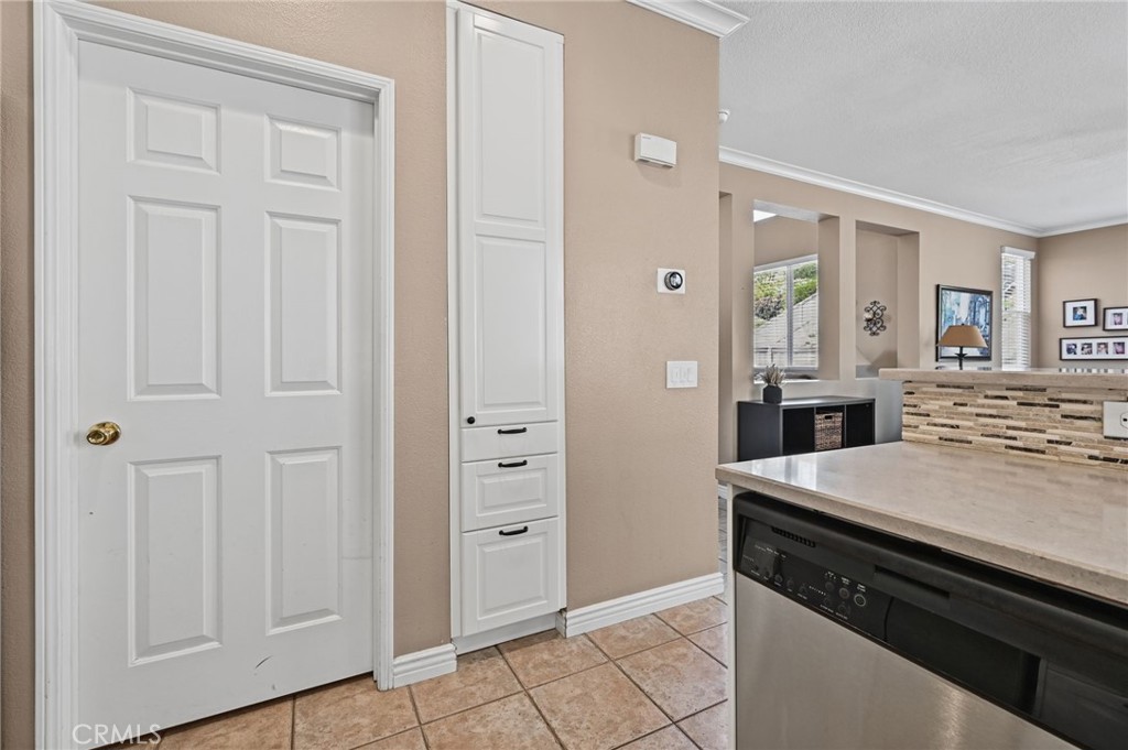 This door leads to the Laundry Room. The cabinet on the right is perfect for storing things. - 1028 S Brianna Way, Anaheim CA 92808 - photo 27