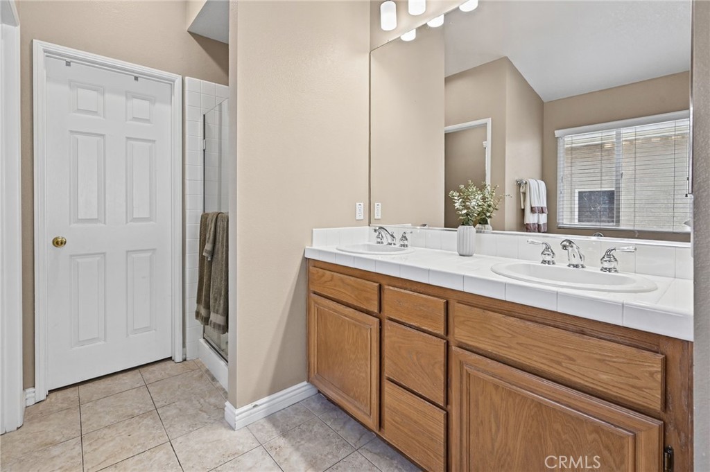 Primary Bathroom has a Double Vanity, Walk in Closet, and Walk in Shower - 1028 S Brianna Way, Anaheim CA 92808 - photo 33