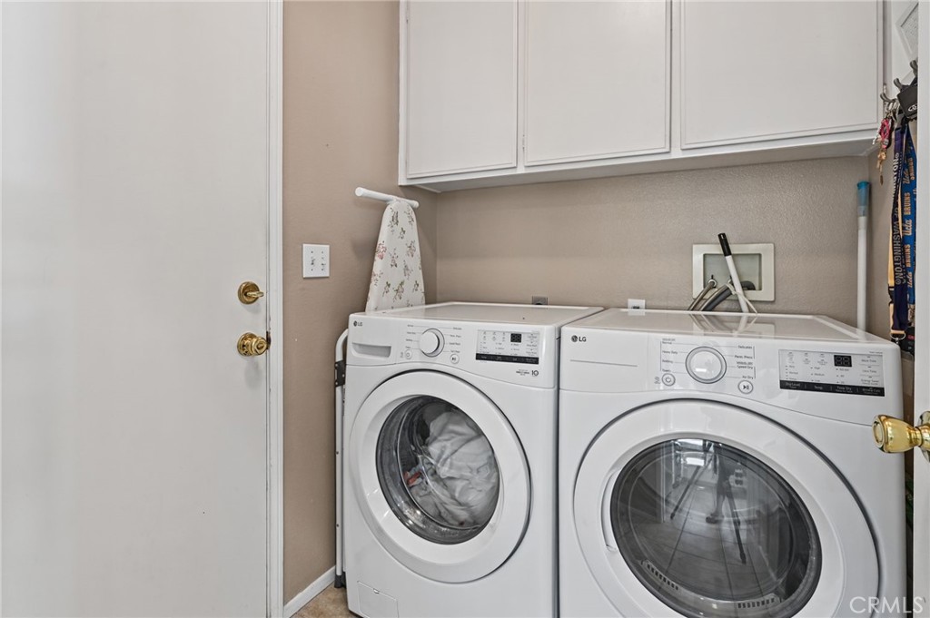 Inside Laundry Room has storage cabinets. This room sits next to the kitchen. - 1028 S Brianna Way, Anaheim CA 92808 - photo 41