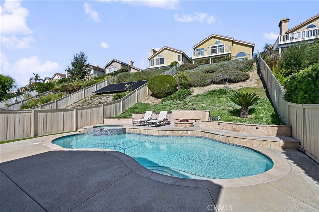 Private Pool & Spa was resurfaced and re-tiled last year. A fire pit and seating sit next to the pool and just below the - 1028 S Brianna Way, Anaheim CA 92808 - photo 42