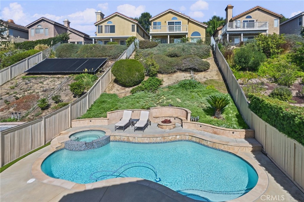Private Pool & Spa was resurfaced and re-tiled last year. A fire pit and seating sit next to the pool and just below the - 1028 S Brianna Way, Anaheim CA 92808 - photo 43