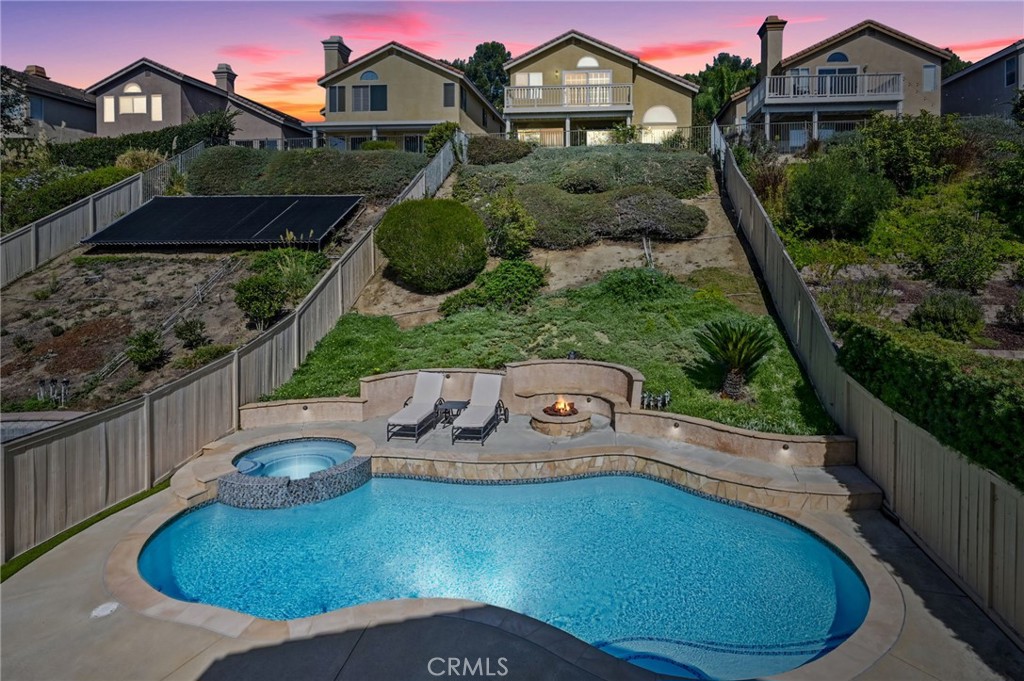 Private Pool & Spa was resurfaced and re-tiled in 2025 A fire pit and seating are sit next to the pool and just below th - 1028 S Brianna Way, Anaheim CA 92808 - photo 50