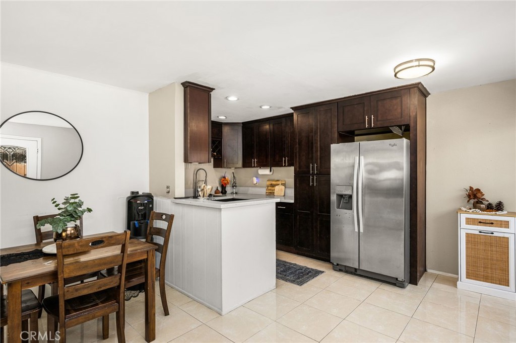 View into the kitchen and dining area from the entry - 134 S Magnolia Avenue 2C, Anaheim CA 92804 - photo 4
