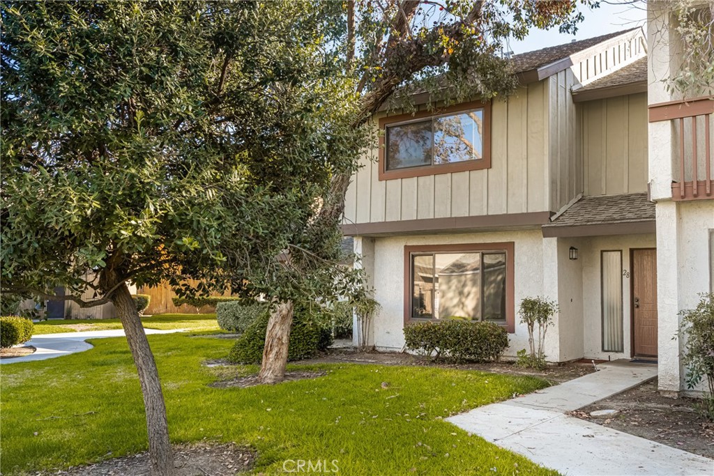 Mature trees and the green belt location make this end-unit townhome ideal. - 1451 S Walnut St 28, Anaheim CA 92802 - photo 1