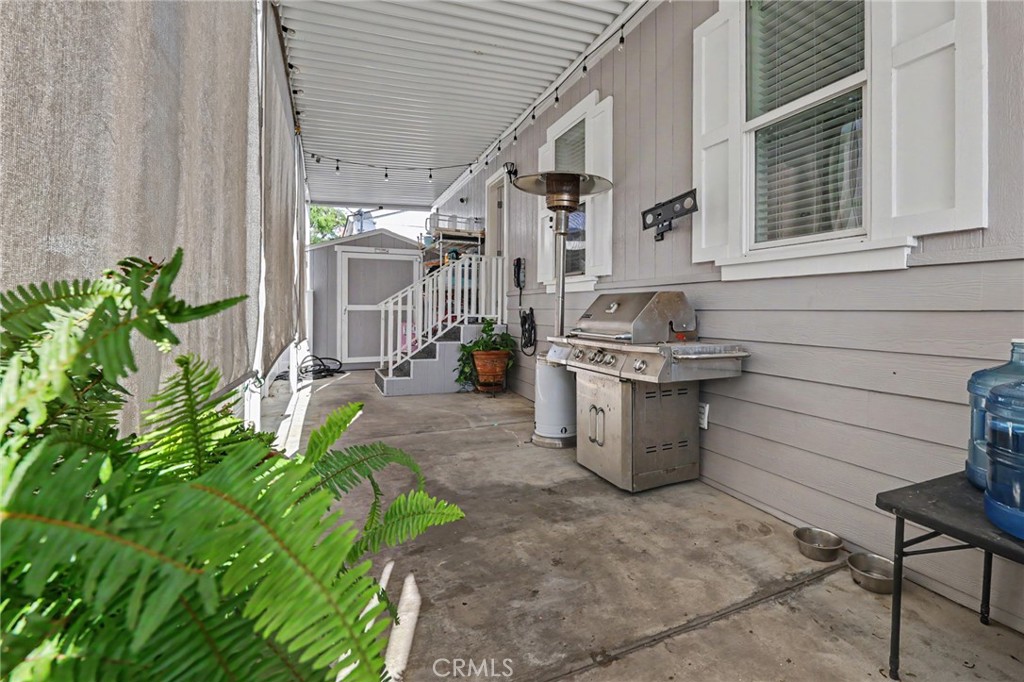 Attached carport with privacy shades and storage shed access - 250 W Midway Drive 2, Anaheim CA 92805 - photo 14