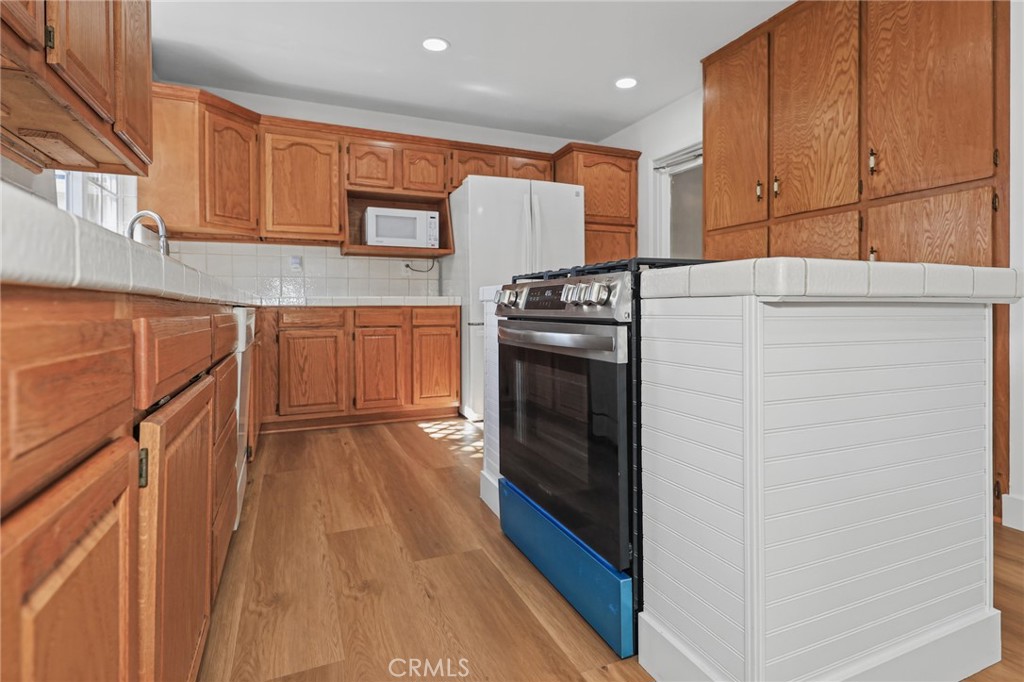 Lower cabinets and island - 3122 W Glen Holly Drive, Anaheim CA 92804 - photo 21