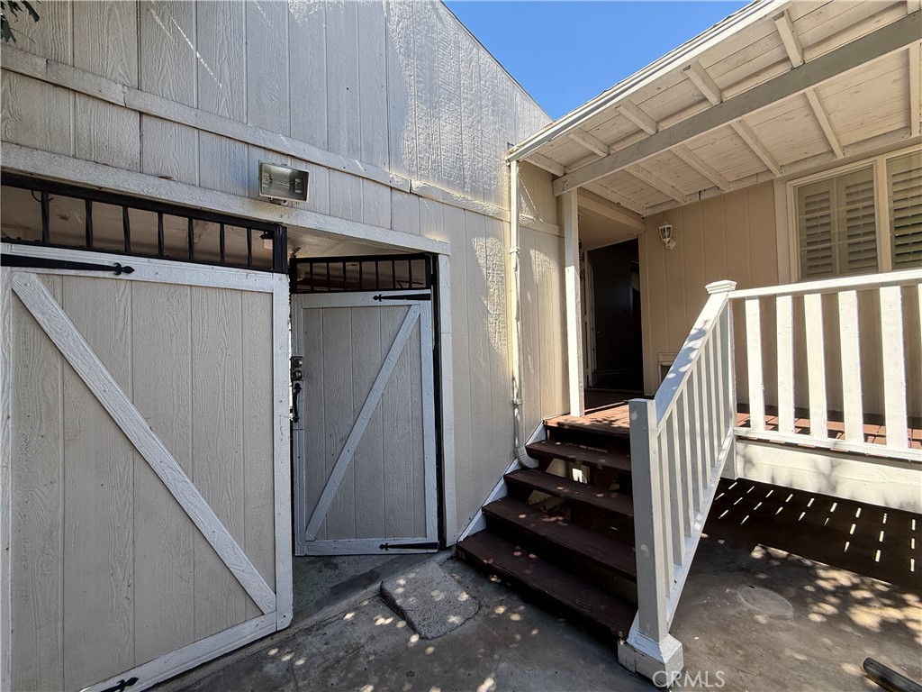 Back patio overseeing deck and back of garage - 320 N Park Vista Street 116, Anaheim CA 92806 - photo 19