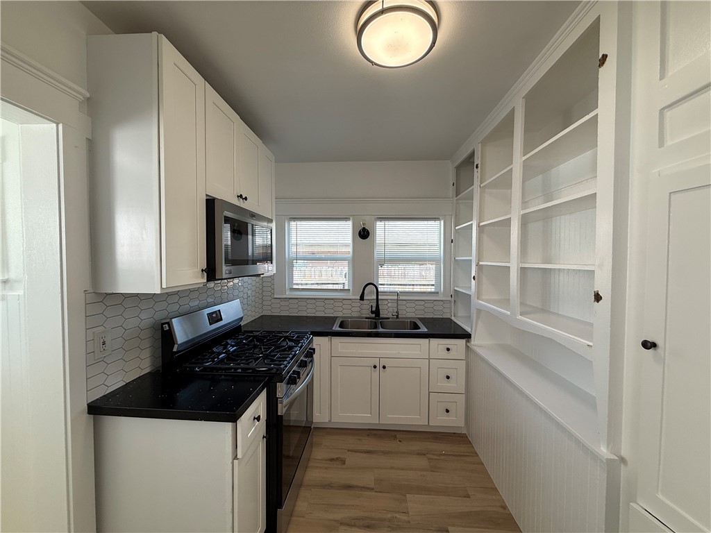 Kitchen with white cabinets and quartz counters - 323 S Kroeger Street, Anaheim CA 92805 - photo 7