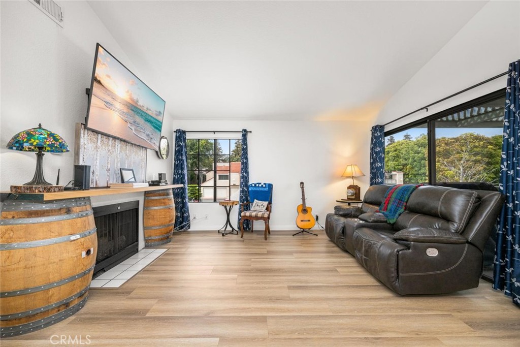Spacious living area with gas fireplace and access to the patio - 3572 W Stonepine Lane F, Anaheim CA 92804 - photo 1