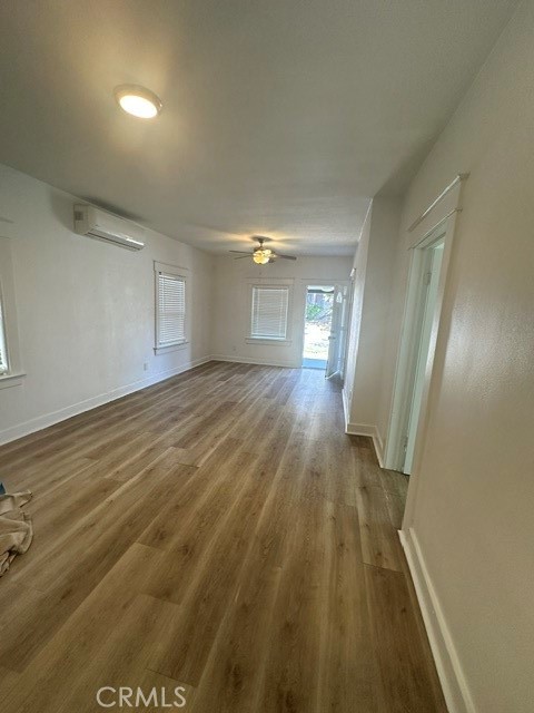 Livingroom with ceiling fan and lament flooring throughout - 423 S Helena, Anaheim CA 92805 - photo 4