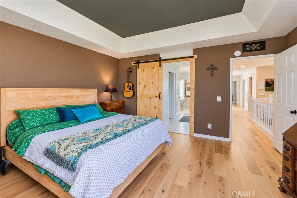 Spacious Primary Bedroom with view and custom fireplace mantel - 740 S Crown Pointe, Anaheim CA 92807 - photo 12