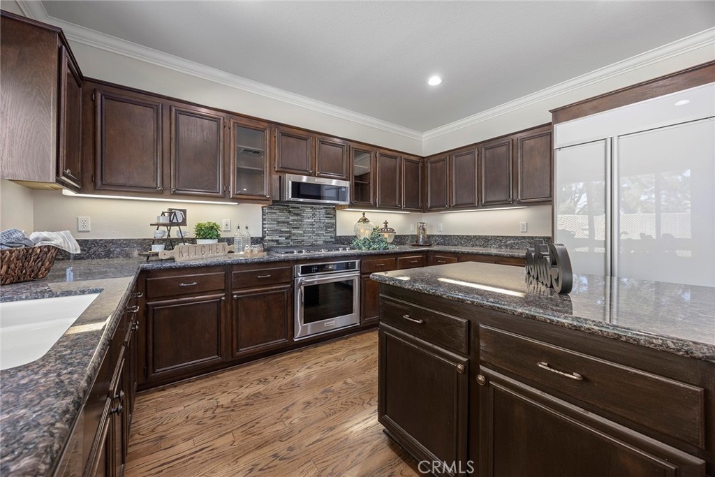 Granite countertops and built in refrigerator. Island allowing plenty of counter space and storage. - 8751 E Running Springs Drive, Anaheim Hills CA 92808 - photo 13