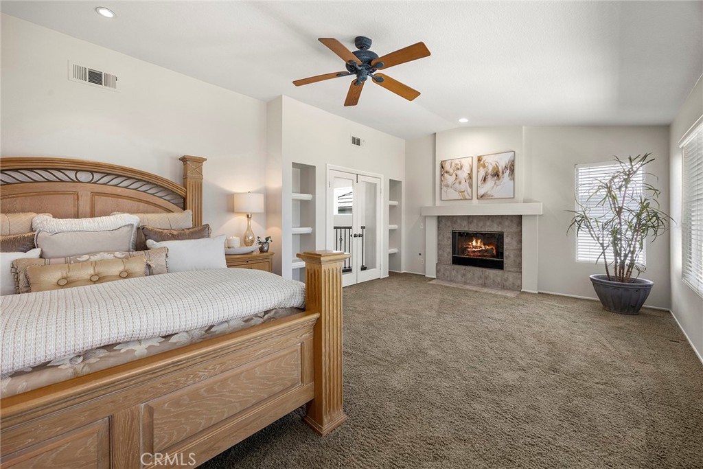 The oversized Primary Bedroom gives you a great retreat area with fireplace and high vaulted ceilings, with designated r - 8751 E Running Springs Drive, Anaheim Hills CA 92808 - photo 21