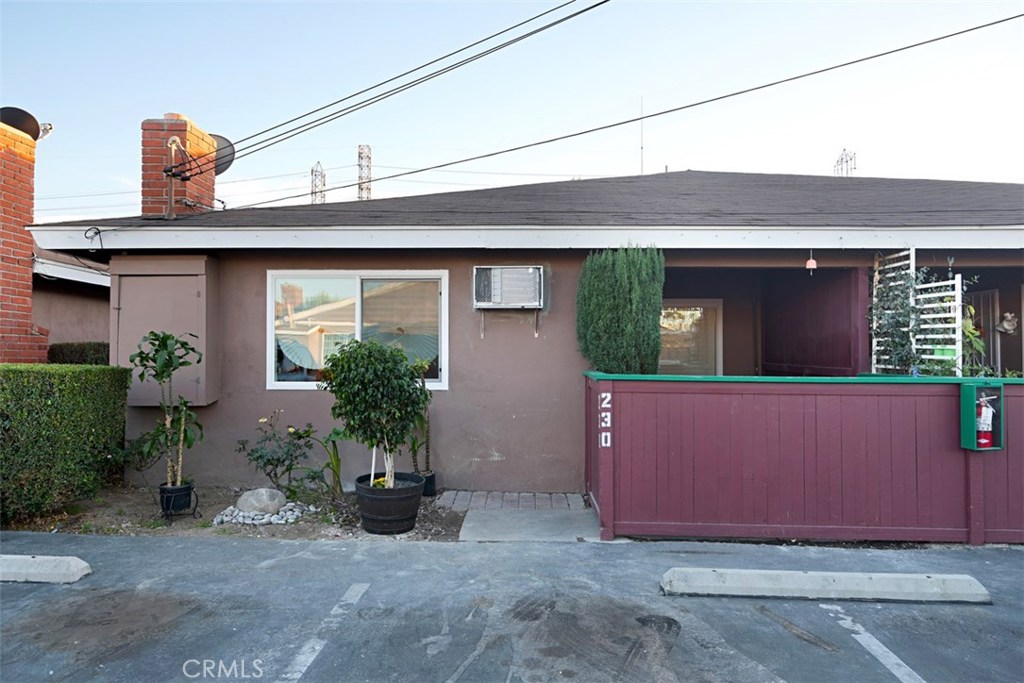 Exterior view of the unit with enclosed private patio, new double pane window and wall AC - 9155 Pacific Avenue 230, Anaheim CA 92804 - photo 1