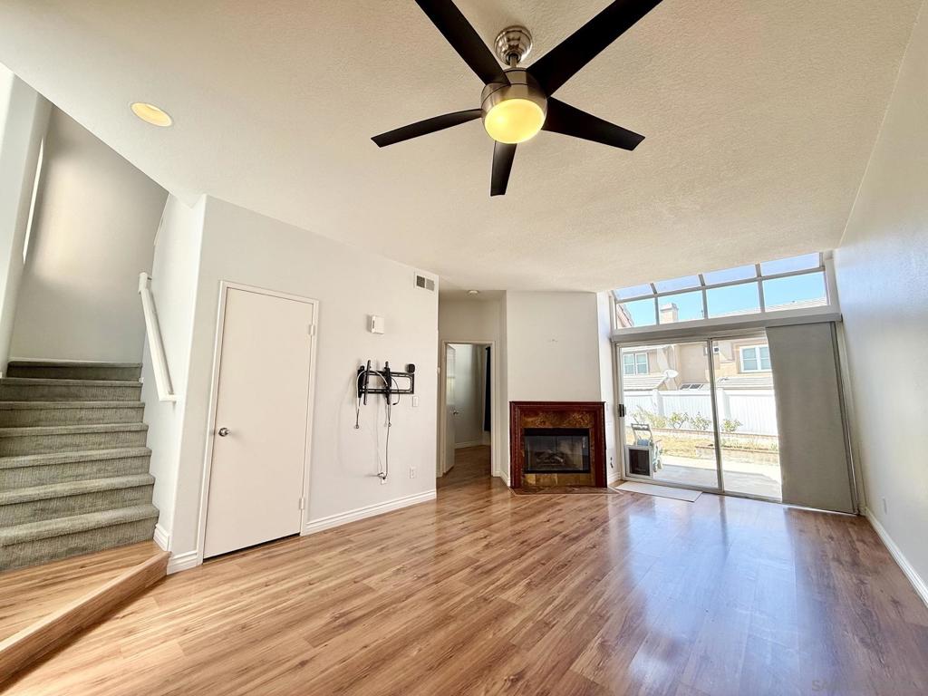 Open concept living room & dining combo with access to downstairs bedroom and full bathroom, gas fireplace, and a slidin - 992 S Country Glen Way, Anaheim CA 92808 - photo 1