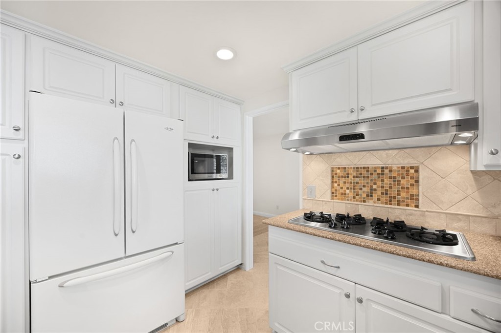Gas burners and looking into dining room - 1811 Ravencrest, Brea CA 92821 - photo 10