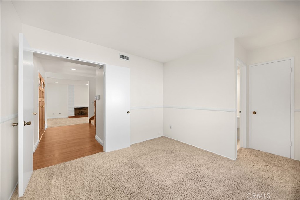 Bedroom 1 showing closet door right side and door to downstairs full bathroom - 1811 Ravencrest, Brea CA 92821 - photo 18