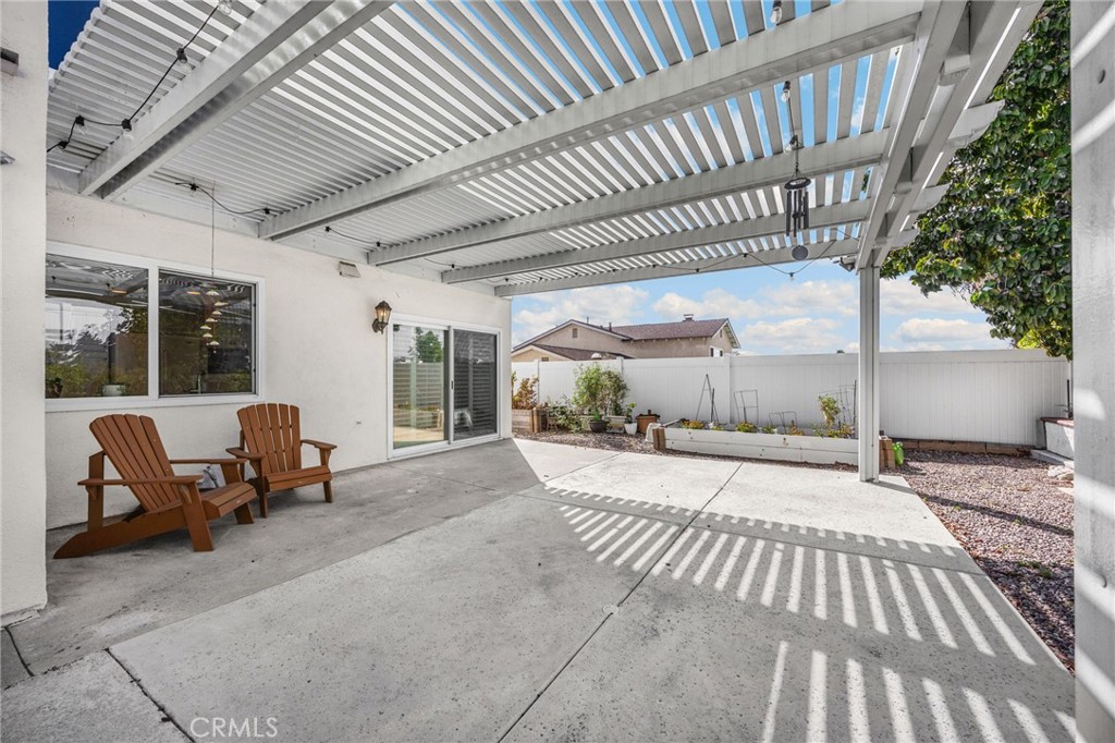 Large patio with open slat covering and view of raised garden - 1811 Ravencrest, Brea CA 92821 - photo 31