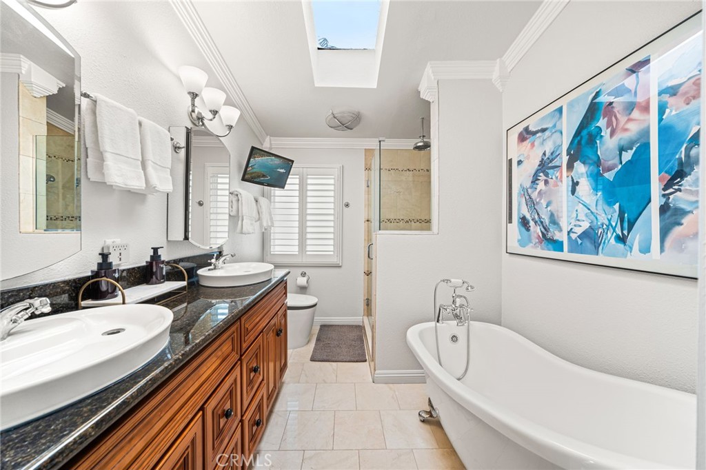 Primary bathroom with double sink and soaking tub - 5431 Rockledge Drive, Buena Park CA 90621 - photo 37