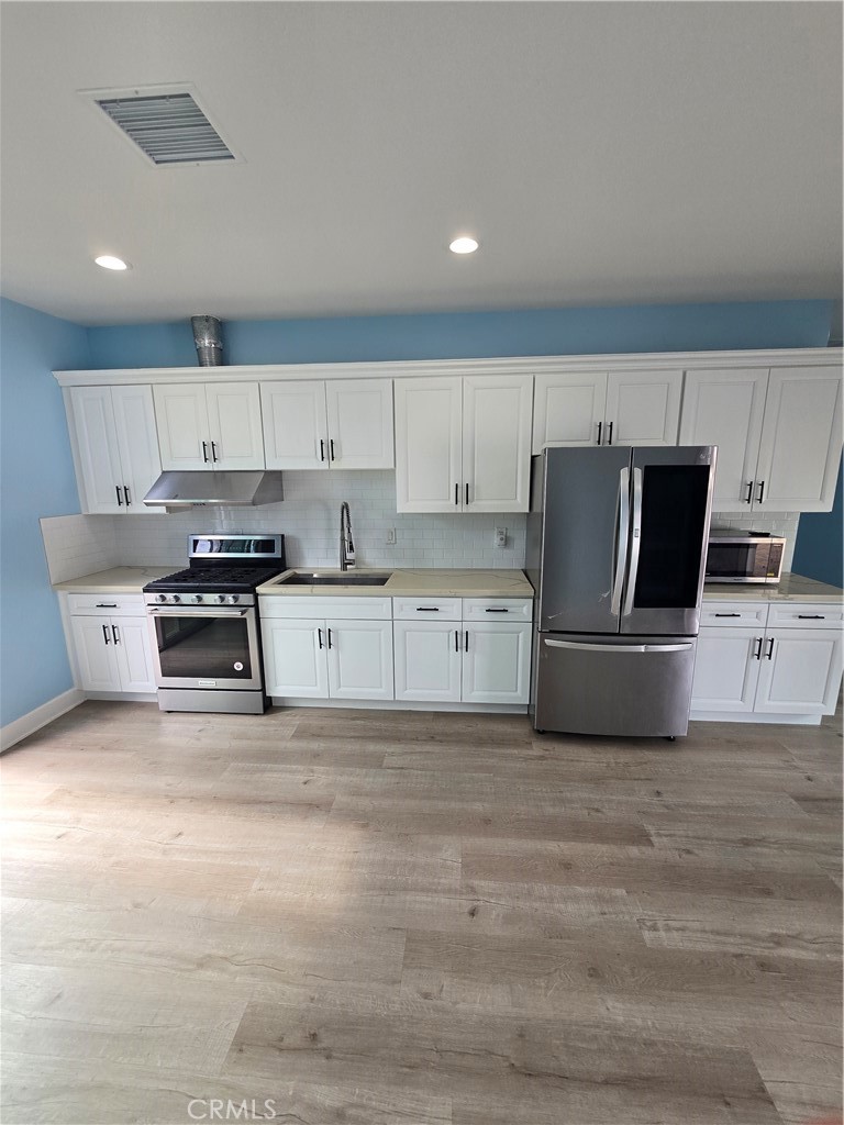 Newer kichen with white shaker cabinets - 5451 Lockhaven Drive B, Buena Park CA 90621 - photo 4